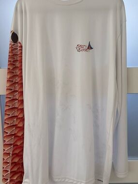 Fishing shirt. Red fish scales down the arm.